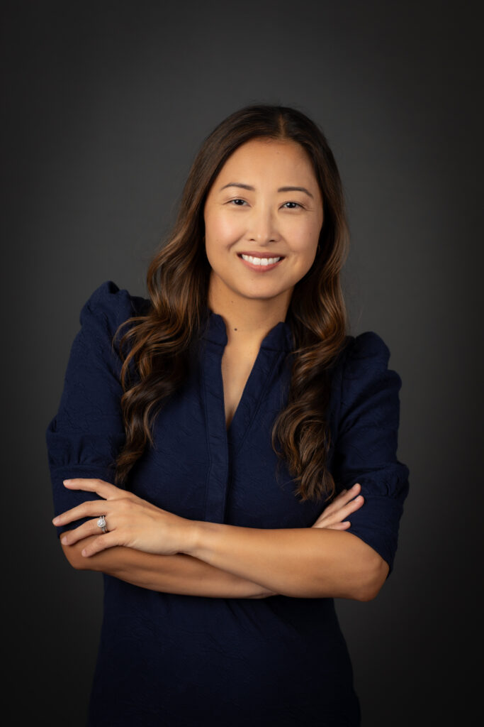 Woman confidently smiles for her in-studio professional headshot by Kat Jones Creative