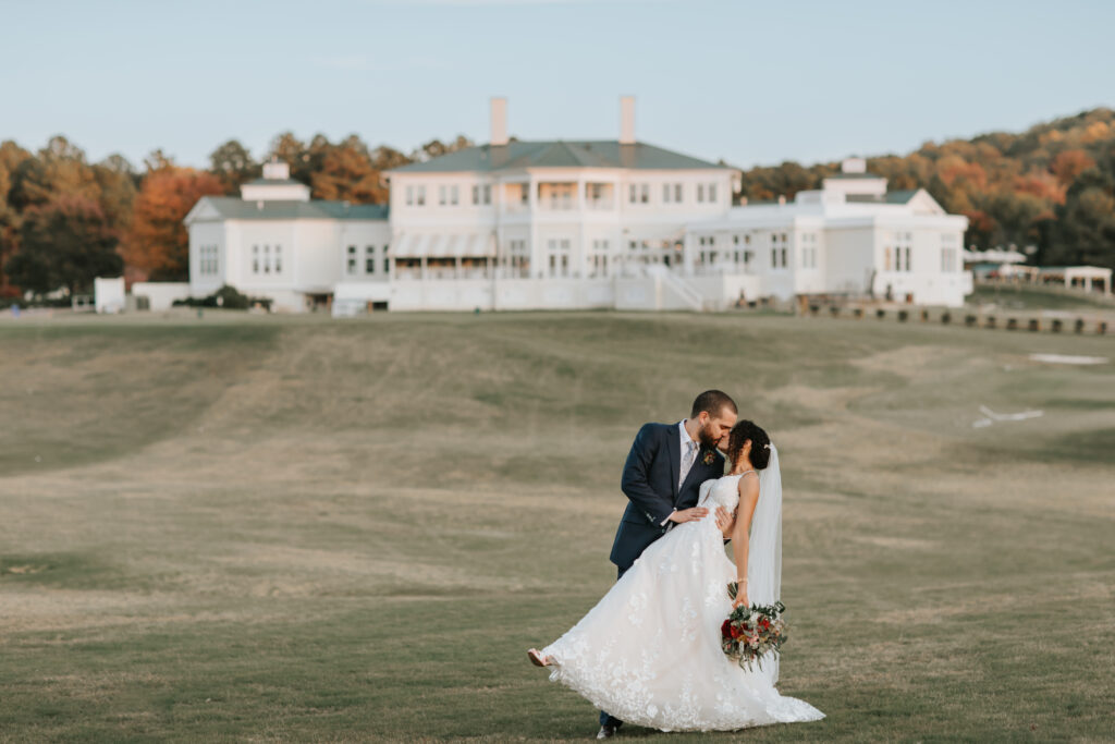 Groom dips bride at The Estate at Independence on their wedding day captured by Kat Jones Creative