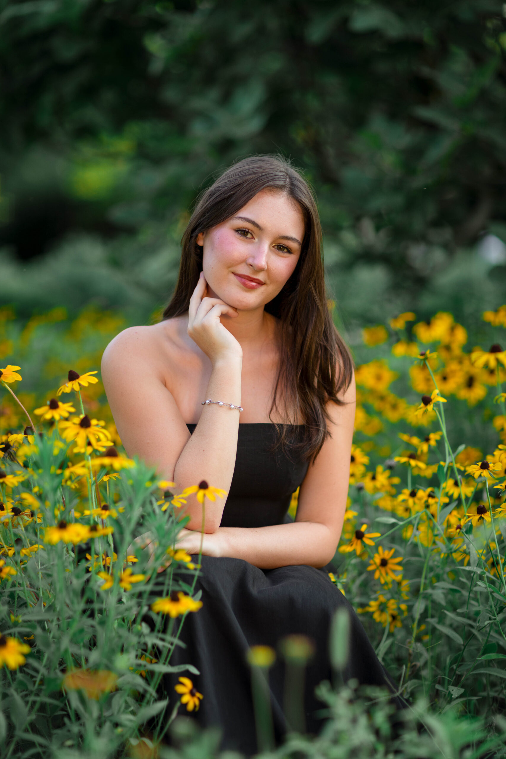Richmond, Virginia High School Senior girl posing for her senior portraits in a field of Black-Eyed Susans by Senior photography Kat Jones Creative