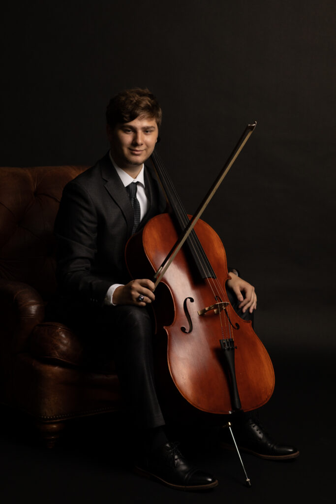Dramatic Fine Art portrait of High School senior holding his cello in Kat Jones Creative photography studio in Richmond, Virginia. 